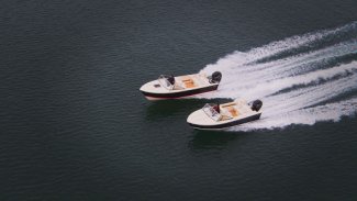 two rossiter boats speeding along Gordon Bay water