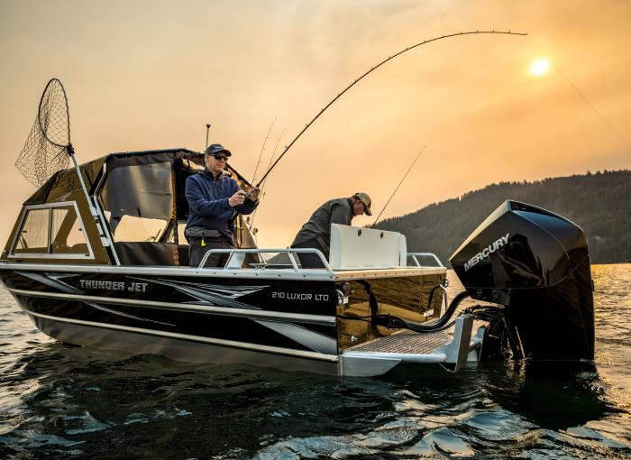 Men fishing in a Thunder Jet 210 Luxor LTD powered by a mercury outboard